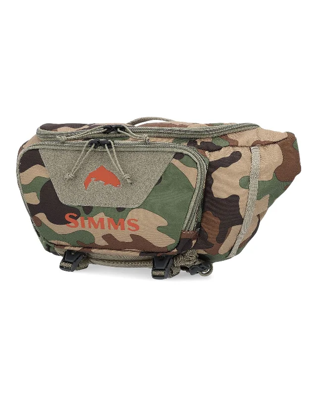 Fishing bait dispensing tool-Simms Tributary Hip Pack Woodland Camo